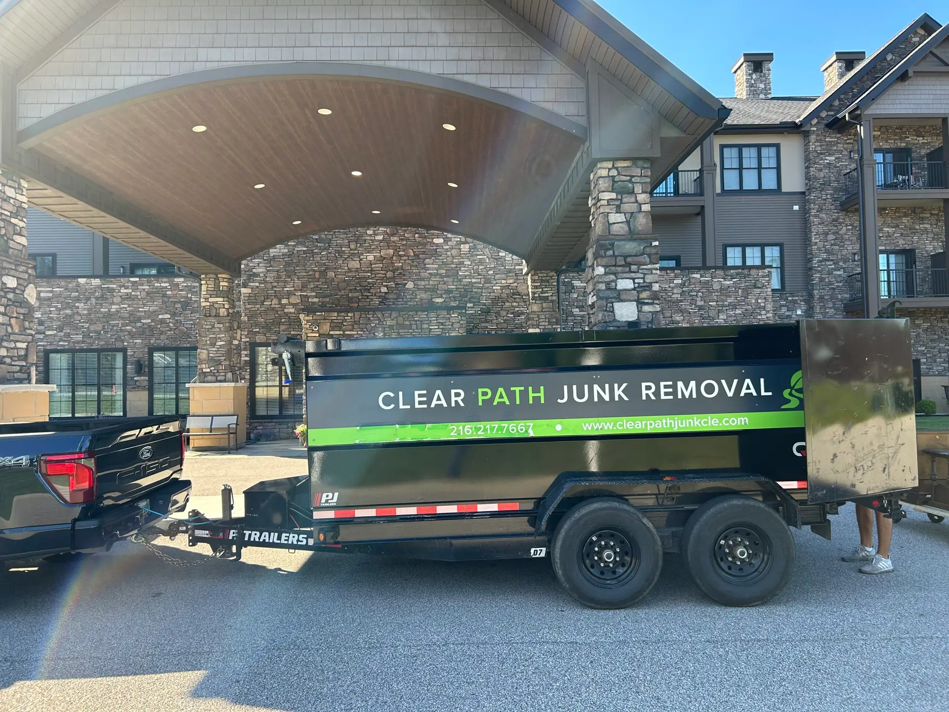 Clear Path Junk Removal truck and trailer providing commercial property cleanout services in North Olmsted, OH.