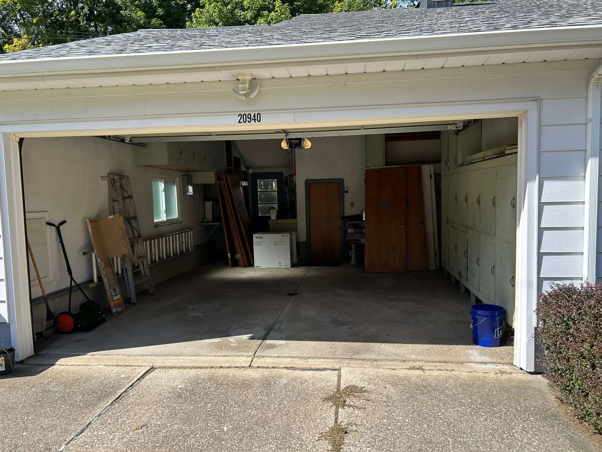 A clean, swept residential garage in Fairview Park, OH, completely cleared of junk and debris after a professional cleanout service.
